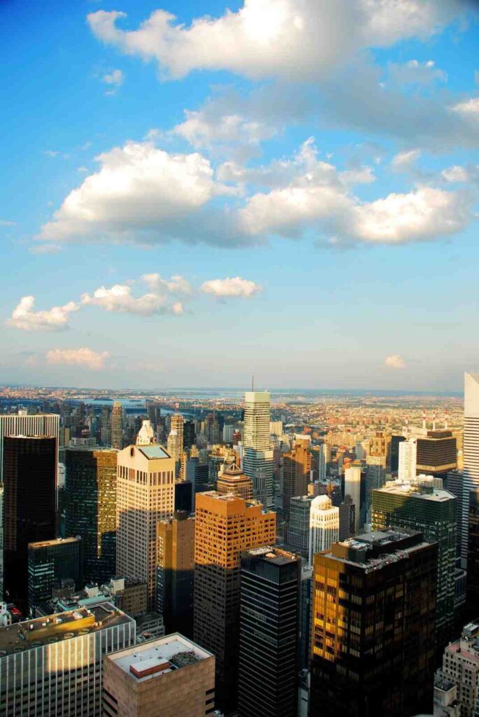 New York City skyline under blue sky with clouds