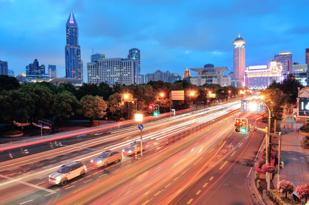 Modern city skyline with traffic light trails at night