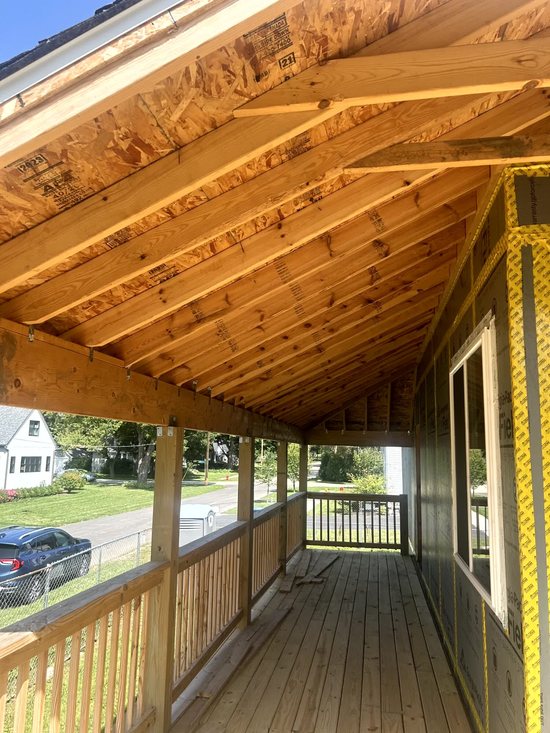 Covered front porch interior with exposed rafters