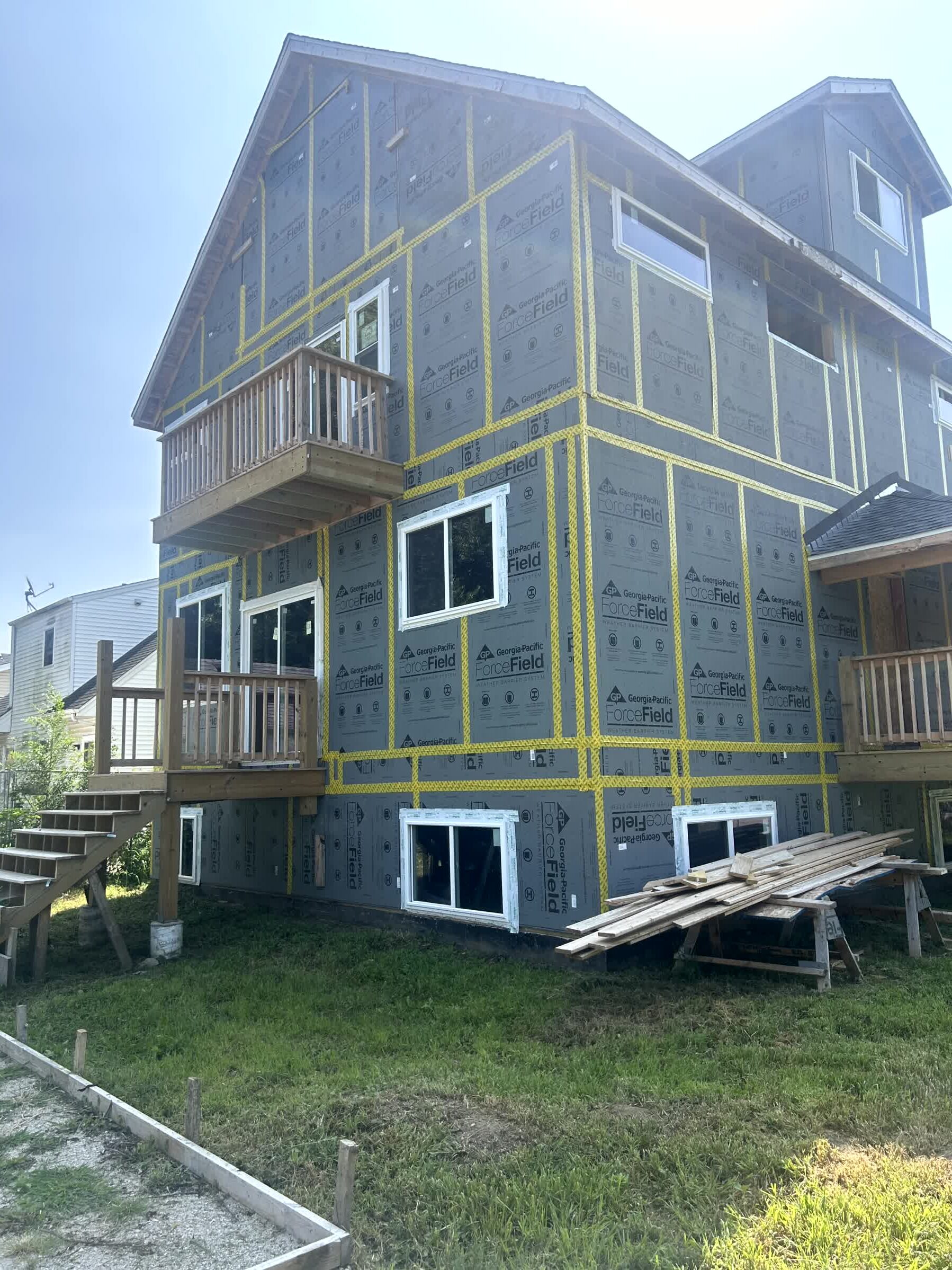 Rear exterior with three-story facade and balcony